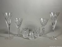 Full group showing all seven Waterford Crystal pieces: 2 tumblers, 2 water goblets, 2 flutes, 1 mustard jar with lid.