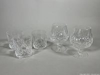 Photo showing two Waterford Crystal Lismore snifter glasses and three rocks glasses.
