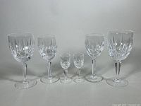 Full set of six Waterford crystal glasses showing two cordial glasses, two claret glasses, and two water goblets with cut crystal patterns.