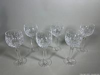 Six Waterford Lismore hock wine glasses arranged in a group showing their overall shape and pattern.
