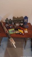Overall view of all camping and survival items on table