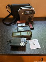 Group shot of all items including radios, camera, cases and carry bag