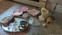 Full view of all ceramic decor, tray, jewelry box, jewelry items, and other small decor pieces arranged on a carpet.