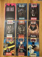 Nine bagged Legends of the Dark Knight issues (#1-9) arranged 3×3 on wood surface.