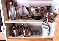 Full shelving view showing all stainless and ceramic items