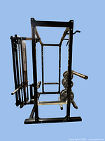 Powertec rack frame with plate storage posts and dip arms visible