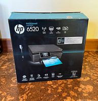 Box of HP Photosmart 6520 showing product image and features