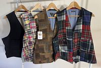 Front view of all four vests on hangers