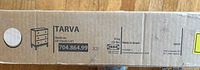 Sealed IKEA TARVA dresser box showing product label, model number 704.864.99, weight 10 kg, made in Brazil.