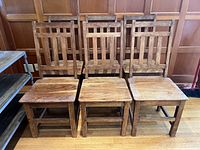 Front view of all six matching ladder-back chairs