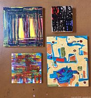 Four smaller abstract paintings front view