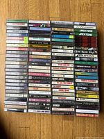 First stack of approx 70 cassette spines showing artist and album titles