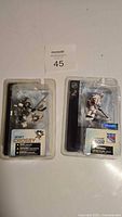 Two McFarlane Hockey Figures side-by-side in original packaging, showing Sidney Crosby (Pittsburgh Penguins) and Jaromir Jagr (Washington Capitals). Packagings are slightly damaged.