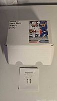 Closed white box labeled 2021/23 Upper Deck Series 1 (cards 1-200) with hockey player images on top.