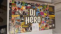DJ Hero original PlayStation 3 box showing colorful artwork and game branding.