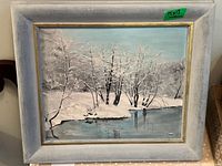 Framed snowy river winter landscape print with trees, signed by Freda Glenn in the bottom left corner, size 15x13 inches.