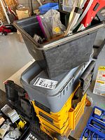 Photo of Mastercraft yellow resin stacking toolbox with black removable bin on top containing various tools and accessories.