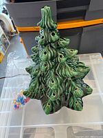 Top and side view of the green ceramic Christmas tree with holes for lights.