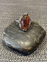 Front view of marquise amber ring on stone
