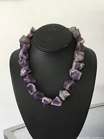 Front view of amethyst nugget necklace on display bust