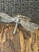 Front view of sterling silver dragonfly ring showing motif and markable texture