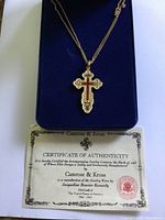 Necklace displayed in velvet box with certificate visible
