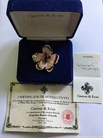 Brooch in open Camrose & Kross box with certificate and authenticity card visible