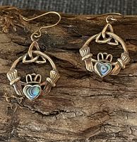 Front view of both earrings showing Claddagh motif, abalone inlay and rose gold-tone finish