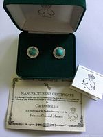 Open Clarion-Pell box showing earrings, certificate and booklet