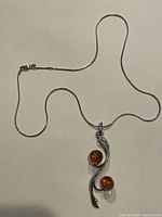 Full view of sterling chain and amber pendant