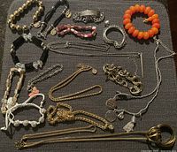 Full layout of all bracelets and necklaces on fabric background