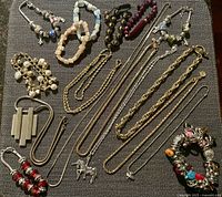 Full lot overview showing bracelets, necklaces, earrings and pendant