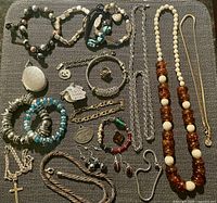 Overall view of all jewellery items laid out on fabric