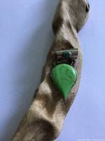 Front view of pendant on driftwood showing overall design