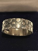 Front view of textured sterling silver band ring