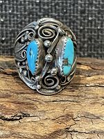 Front view showing turquoise stones and silver scrollwork