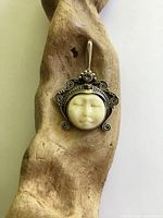 Front view of sterling silver moon face pendant with amethyst