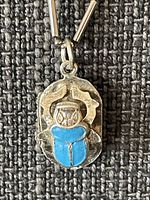 Front view of pendant showing blue scarab in silver setting