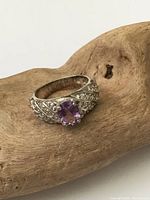 Front view of sterling silver ring with amethyst and accent stones