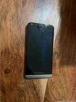 Front view of BlackBerry smartphone on wooden surface