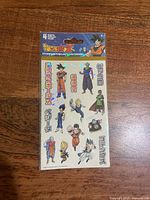 Front of sealed Dragon Ball Z Sandylion sticker pack showing characters and 4 sheets note