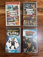Front view of four PSP game cases: GTA Vice City Stories, GTA Liberty City Stories, Secret Agent Clank, Ratchet & Clank Size Matters