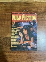 Front view of Pulp Fiction tin sign with hanging cord