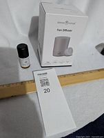 Serene House Fan Diffuser boxed next to a 12 inch ruler and MaxSold tag, showing compact size and packaging.