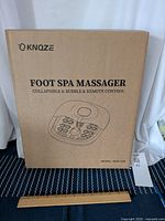 Original packaging box of Knoze foot spa massager showing product name and model number MZD-017.