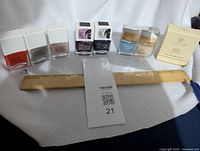 Full view of nail polish and nail care set, shows 7 polishes, 2 nail care jars, boxed product, and magnets