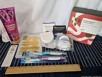Photo shows Bath & Body Works Twisted Peppermint Ultra Shea Body Cream, Lemon Sliced Mask, two new toothbrushes, a white night guard in case, unopened snore guard box and peppermint twist duo box
