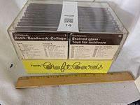 Plastic box filled with vintage craft instruction cards arranged by category and numbered.