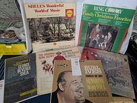 Group photo of 8 Christmas albums from 1940s-1960s showing cover art of different artists and titles including Burl Ives and Bing Crosby