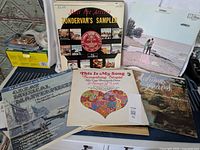 Photo showing six vintage vinyl albums with various covers including Zondervan's Sampler, a romantic song compilation, and Autumn Leaves piano album.